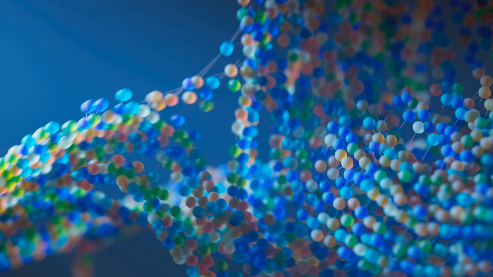 Representação molecular abstrata com esferas coloridas conectadas sobre fundo azul.